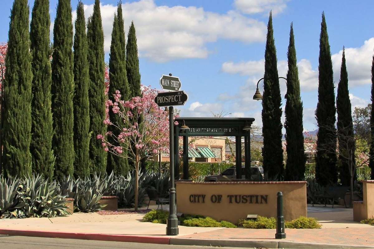 City of Tustin sign and street sign with trees